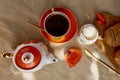 Traditional poppy seed bun with cup of tea and milk near poppies flowers and dishes with poppies ornaments. Delicious Royalty Free Stock Photo