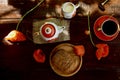 Traditional poppy seed bun with cup of tea and milk near poppies flowers and dishes with poppies ornaments. Delicious Royalty Free Stock Photo