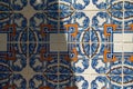 Traditional portugal tiles in blue and orange on white azulejo. Close up of colorful portuguese art and architecture symbol with