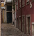 Traditional Portuguese architecture with stone door frames in a dark street in Porto, Portugal