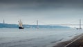 Traditional Portuguese caraval on River Tagus, Lisbon, Portugal with 25 April Bridge in background Royalty Free Stock Photo