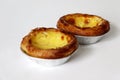 Traditional Portuguese custard pastry called a pasteis de nata isolated on white background