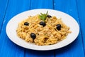 Traditional portuguese dish bacalhau a bras on white plate on wooden background