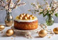 A traditional Portuguese Easter cake with golden eggs and flowers on a table Royalty Free Stock Photo
