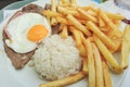 Traditional Portuguese food Prego no Prato with rice, chips, egg and beef. Royalty Free Stock Photo