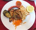 Traditional Portuguese grilled meat platter with vegetables