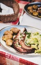 Traditional portuguese grilled octopus, boiled potato and cabbage on plate Royalty Free Stock Photo