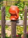 Traditional pot hanging on a wooden fence