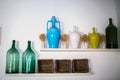 Traditional pottery of Puglia, Italy, colorful amphora for wine and big bottele for wine and olive oil on a white wall