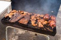 Traditional Poulet Boucane smoked chicken and ribs cooking in BBQ barrel in Martinique Royalty Free Stock Photo