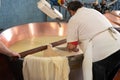 Process of making wheels of parmigiano-reggiano parmesan cheese on small cheese farm in Parma, Italy, copper-lined vats with curd