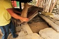 Traditional processing of rice by hand, after threshing the rice kernels, grains get winnowed, seperated from the peels with a Royalty Free Stock Photo