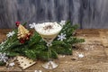 Traditional prune dessert with nuts and whipped sour cream with sugar. New Year`s sweet treat concept. Wooden boards background Royalty Free Stock Photo