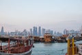 Traditional Qatari dhow boats with the skyline of Doha West Bay skyscrapers