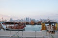 Traditional Qatari dhow boats with the skyline of Doha West Bay skyscrapers Royalty Free Stock Photo
