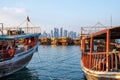 Traditional Qatari dhow boats with the skyline of Doha West Bay skyscrapers Royalty Free Stock Photo