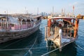 Traditional Qatari dhow boats with the skyline of Doha West Bay skyscrapers