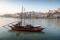 Traditional Rabelo boat with wine barrels at Douro River with Porto Skyline - Porto, Portugal