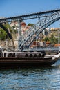 Traditional Rabelo Boats on the Bank of the River Douro and Dom Luis I Bridge in background - Porto, Portugal Royalty Free Stock Photo