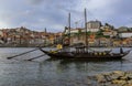 Traditional rabelo boats with barrels of port wine docked on Douro by famous Portuguese wine cellars in Porto, Portugal Royalty Free Stock Photo