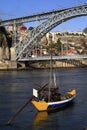 Traditional rabelo boats, Porto city skyline, Douro river and and Dom Luis or Luiz iron bridge. Porto