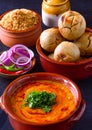 Indian meal in terracotta pots -Dal baati churma