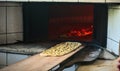 Traditional ramadan bread on bakery shovel being put into the oven in bakery