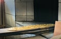 Traditional ramadan bread on bakery shovel being put into the oven in bakery