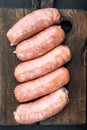 Traditional raw pork sausages, flat lay, on black background