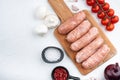 Traditional raw sausages, flat lay, on white background