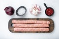 Traditional raw sausages, flat lay, on white background