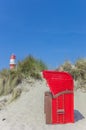 Traditional red beach chair in the dunes of Borkum Royalty Free Stock Photo