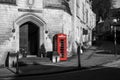 red British phone box is standing on the street of Bradford on Avon