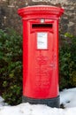 A traditional red British Post Box in a snowy rural setting Royalty Free Stock Photo