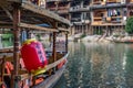 Red lantern on the old wooden boat moored on Tuo river shore in Fenghuang Royalty Free Stock Photo