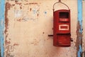 Traditional red color old Indian mailbox postbox Letter box on old textured wall