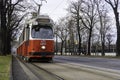 Traditional red electric tram in the streets of Vienna on a late winter afternoon