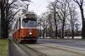 Traditional red electric tram in the streets of Vienna on a late winter afternoon