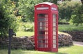 Traditional red English phone box ina country lane Royalty Free Stock Photo
