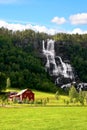 Red farm next to a waterfall. Royalty Free Stock Photo