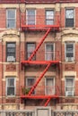 Red fire escape of an apartment building in New York city