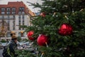 Traditional red and green Christmas tree decorations on Berlin city street. Red Christmas balls on green conifer tree branches Royalty Free Stock Photo