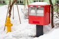 A traditional red japanese postbox at winter time covered Royalty Free Stock Photo