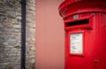 Traditional red mail letter box and red bus in motion in London, the UK Royalty Free Stock Photo
