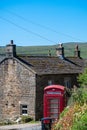 Traditional Red Phone box and cottage Royalty Free Stock Photo