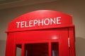 Traditional red phone box stands indoors as a symbol of London and the UK Royalty Free Stock Photo