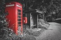 Traditional red telephone booth, post box and a bus stop in the UK, selective color Royalty Free Stock Photo