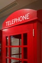 Traditional red telephone booth stands indoors as a symbol of London and the UK Royalty Free Stock Photo