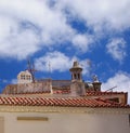 A traditional red tile rooftop with chimneys in a portuguese town Royalty Free Stock Photo