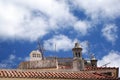 A traditional red tile rooftop with chimneys in a portuguese town